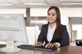 Happy asian business woman working with a desktop computer Royalty Free Stock Photo