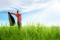 Happy asian businessman with open arms holding a suit standing on the grass Royalty Free Stock Photo