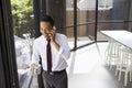 Happy Asian businessman on the phone in modern office