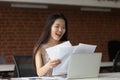 Happy Asian businesswoman reading documents, receiving good news Royalty Free Stock Photo