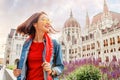 asian casual woman student enjoying great view of the Parliament building in Budapest city, travel in Europe concept Royalty Free Stock Photo