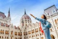 Asian casual woman student enjoying great view of the Parliament building in Budapest city, travel in Europe concept