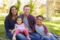 Happy Asian Caucasian mixed race family, portrait in a park