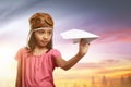 Happy asian child in aviator helmet playing with paper planes Royalty Free Stock Photo