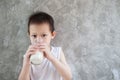 Asian child boy drinking milk in breakfast time Royalty Free Stock Photo