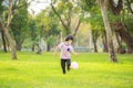 A happy Asian child with colorful toy balloons outside the house. Smiling child having fun in green spring field on blue sky Royalty Free Stock Photo