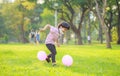 A happy Asian child with colorful toy balloons outside the house. Smiling child having fun in green spring field on blue sky Royalty Free Stock Photo