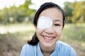 Happy asian child girl cover with blindfolded bandaged eye after surgery or treatment of strabismus,lazy eye, hygienic,prevent Royalty Free Stock Photo