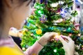 Happy asian child girl decorating Christmas tree with gifts box and ornaments,beautiful decorate Xmas tree at night, female people Royalty Free Stock Photo