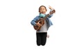 Happy Asian child girl jumping play ukulele, isolate on white Royalty Free Stock Photo