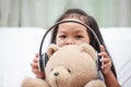 Happy asian child girl playing with her teddy bear