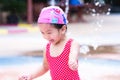 Happy Asian child girl playing water. Laughing children. Kids run around in the fountain. Royalty Free Stock Photo