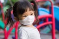 Happy Asian child girl smiling and wearing fabric mask Royalty Free Stock Photo