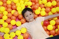 Happy Asian child playing at colorful plastic balls playground Royalty Free Stock Photo