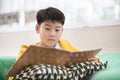 Happy asian child reading book with smile face. Royalty Free Stock Photo