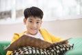 Happy asian child reading book with smile face. Royalty Free Stock Photo