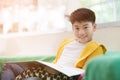 Happy asian child reading book with smile face. Royalty Free Stock Photo