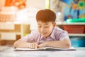 Happy asian child reading book with smile face. Royalty Free Stock Photo