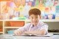 Happy asian child reading book with smile face. Royalty Free Stock Photo