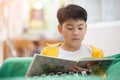 Happy asian child reading book with smile face. Royalty Free Stock Photo