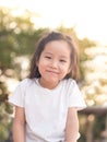 Happy Asian child on a seesaw in sunset light