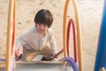 Happy asian child on slide