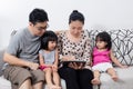 Happy Asian Chinese Family Playing with Digital Tablet Together Royalty Free Stock Photo