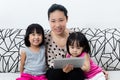 Happy Asian Chinese Family Playing with Digital Tablet Together Royalty Free Stock Photo