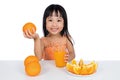 Happy Asian Chinese little girl drinking orange juice Royalty Free Stock Photo