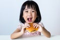 Happy Asian Chinese little girl Eating Burger Royalty Free Stock Photo