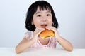 Happy Asian Chinese little girl Eating Burger Royalty Free Stock Photo