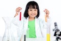 Happy Asian Chinese Little Girl Examining Test Tube With Uniform Royalty Free Stock Photo