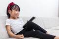 Happy Asian Chinese little girl holding a TV remote control Royalty Free Stock Photo