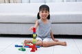 Happy Asian Chinese little girl playing blocks on the floor Royalty Free Stock Photo