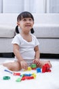 Happy Asian Chinese little girl playing blocks on the floor Royalty Free Stock Photo