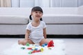 Happy Asian Chinese little girl playing blocks on the floor Royalty Free Stock Photo