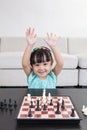 Happy Asian Chinese little girl playing chess chess at home Royalty Free Stock Photo