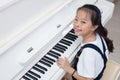 Happy Asian Chinese little girl playing classical piano at home Royalty Free Stock Photo