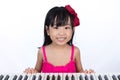 Happy Asian Chinese little girl playing electric piano keyboard Royalty Free Stock Photo