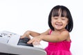 Happy Asian Chinese little girl playing electric piano keyboard Royalty Free Stock Photo