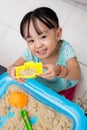 Happy Asian Chinese little girl playing kinetic sand at home Royalty Free Stock Photo