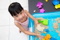 Happy Asian Chinese little girl playing kinetic sand at home Royalty Free Stock Photo