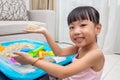 Happy Asian Chinese little girl playing kinetic sand at home Royalty Free Stock Photo