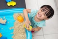 Happy Asian Chinese little girl playing kinetic sand at home Royalty Free Stock Photo