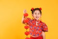 Happy Asian Chinese little girl smile wearing red cheongsam qipao holding silk lanterns Royalty Free Stock Photo