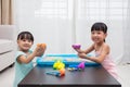 Happy Asian Chinese little girls playing kinetic sand at home Royalty Free Stock Photo