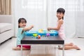 Happy Asian Chinese little girls playing kinetic sand at home Royalty Free Stock Photo