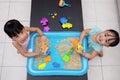 Happy Asian Chinese little girls playing kinetic sand at home Royalty Free Stock Photo