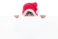 Happy Asian Chinese little santa girl peeking behind blank board Royalty Free Stock Photo