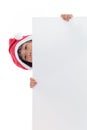 Happy Asian Chinese little santa girl peeking behind blank board Royalty Free Stock Photo